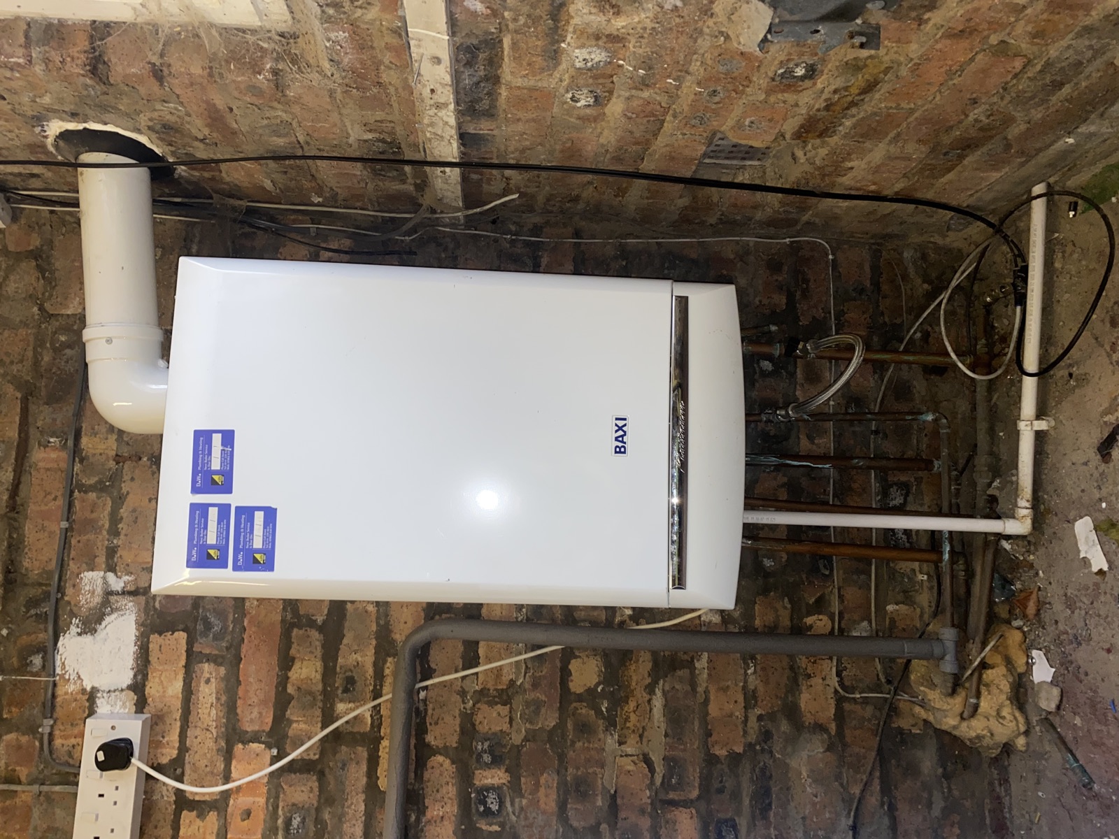 Before: older combi boiler on a recent Coatbridge replacement before a garage conversion