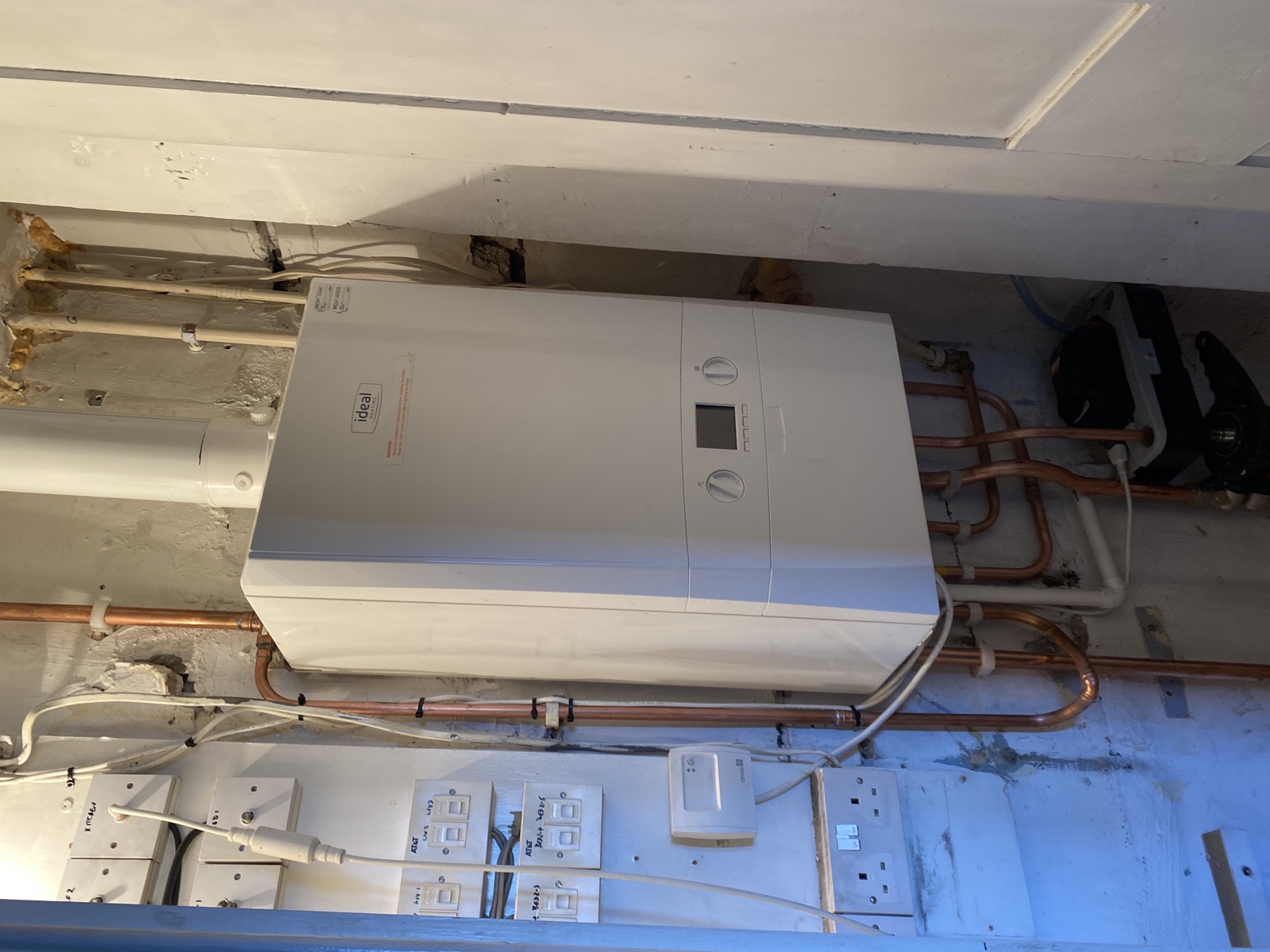 Real Ideal boiler installation with exposed copper pipework finished by FlameTec
